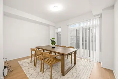 a dining room with a wooden table and chairs at Private Room M A P L E with Attached Full Bathroom in Toronto, ON, Canada in Toronto