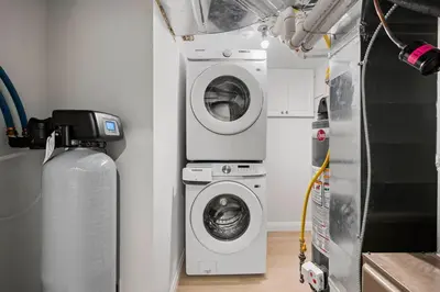 a laundry room with a washer and a washing machine at New 2 bedroom basement apartment in Guelph