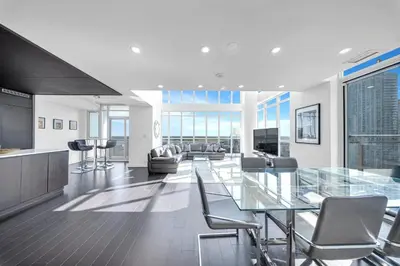 a dining room with a glass table and chairs at RentX 3Bedroom Penthouses near Rogers Centre & MTCC in Toronto