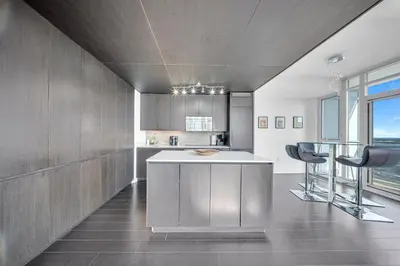 a kitchen with a counter and two bar stools at RentX 3Bedroom Penthouses near Rogers Centre & MTCC in Toronto