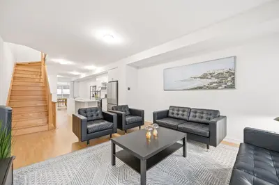 a living room with couches and a table at CEDAR Double Room with attached private Bathroom and Balcony in Toronto, ON, Canada in Toronto