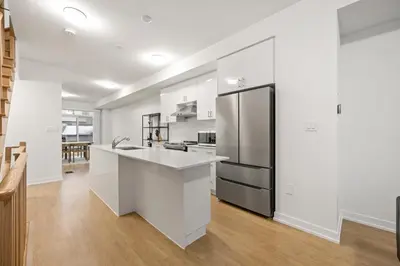 a kitchen with white cabinets and a stainless steel refrigerator at CEDAR Double Room with attached private Bathroom and Balcony in Toronto, ON, Canada in Toronto
