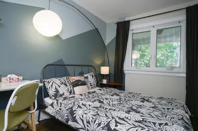 a bedroom with a bed and a table and a window at Spacious Room with Ensuite Bathroom near Subway, Koreatown & UofT in Toronto