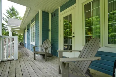 two chairs on the porch of a house at King Bed, Balcony, Pool, Hot Tub, Sauna in Edgar
