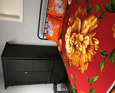 a bed with a dresser with a flower on it at SHAY-BASEMENT-Holiday Home in Pickering