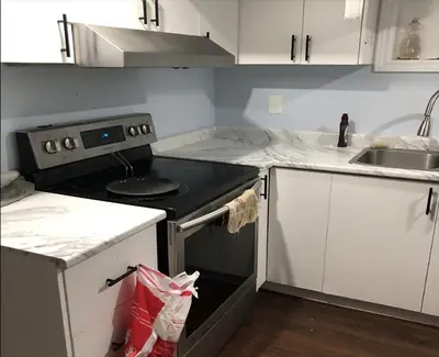 a kitchen with a stove and a sink at SHAY-BASEMENT-Holiday Home in Pickering