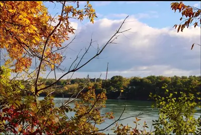 a view of a river with trees in the background at Hummingbird Haven Bed & Breakfast Luxury Suite With Terrace & Seasonal Lake Views Located in Historic Old Town Niagara-On-The-Lake in Niagara on the Lake
