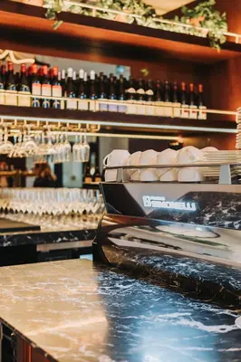 a bar with a counter with bottles of wine at The Postmark Hotel in Newmarket