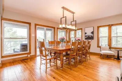 a dining room with a wooden table and chairs at Muskoka Lakeshore Cottage Bliss in Gravenhurst