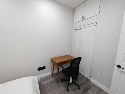 a small room with a desk and a chair at 2BR 1 king 1 Queen with parking 3 GBPS internet in Kitchener