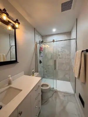 a bathroom with a shower and a toilet and a sink at 2BR 1 king 1 Queen with parking 3 GBPS internet in Kitchener