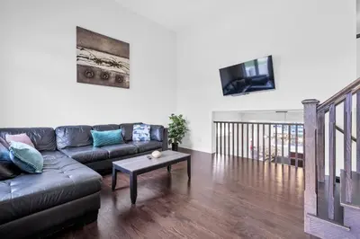 a living room with a couch and a table at 4BR 2 king 3 Queen 6 beds in total 3 GBPS Wi-Fi in Kitchener