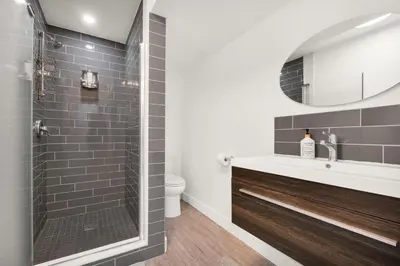 a bathroom with a shower and a sink at Modern 2BR Duplex 3.0 GBPS internet with Parking in Kitchener