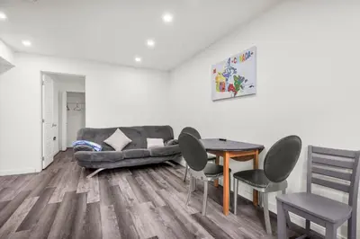 a living room with a couch and a table and chairs at Modern 2BR Duplex 3.0 GBPS internet with Parking in Kitchener