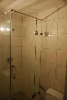 a bathroom with a glass shower with a toilet at Modern 2-BR Basement Apartment in Richmond Hill