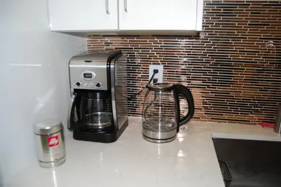 a coffee maker sitting on a counter next to a coffee pot at Modern 2-BR Basement Apartment in Richmond Hill