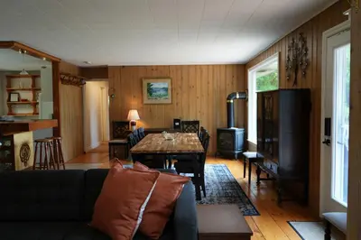 a living room with a couch and a table at Mary Lake Sunset Lodge in Port Sydney