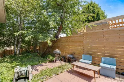 a backyard with a grill and two chairs and a table at Beautiful house near Eglinton GO in Toronto