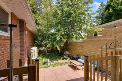 a backyard with a bench and a grill at Beautiful house near Eglinton GO in Toronto