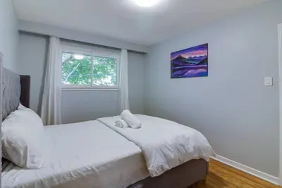 a bedroom with a bed and a window at Beautiful house near Eglinton GO in Toronto
