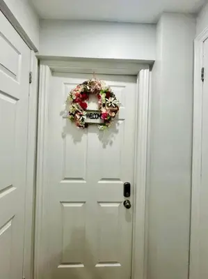 a white door with a wreath on it at Comfort Quarters in Guelph in Guelph