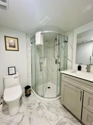 a bathroom with a shower and a toilet and a sink at Comfort Quarters in Guelph in Guelph