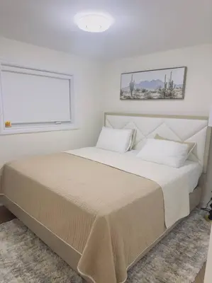 a bedroom with a large bed with a window at South Oakville Bliss Haven Monthly Stays only in Oakville
