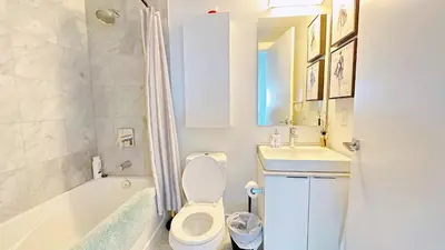 a bathroom with a toilet and a sink and a tub at Superior Lakeview Luxury 3-Bedroom Suite on High Floor in Toronto