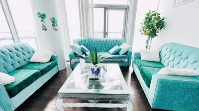 a living room with two blue couches and a table at Superior Lakeview Luxury 3-Bedroom Suite on High Floor in Toronto