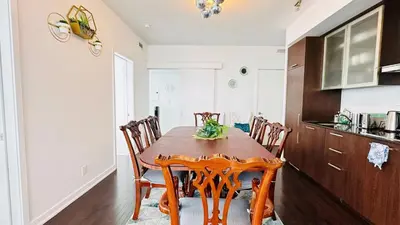 a dining room with a wooden table and chairs at Superior Lakeview Luxury 3-Bedroom Suite on High Floor in Toronto