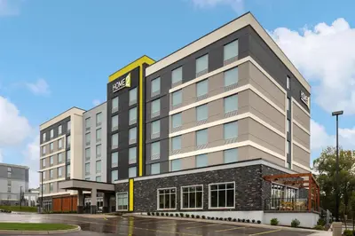 a building with a sign on the side of it at Home2 Suites By Hilton Woodstock On in Woodstock