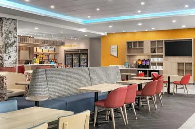 a restaurant with tables and chairs and a bar at Home2 Suites By Hilton Woodstock On in Woodstock