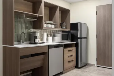 a kitchen with a sink and a refrigerator at Home2 Suites By Hilton Woodstock On in Woodstock