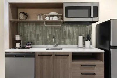 a kitchen with a sink and a microwave at Home2 Suites By Hilton Woodstock On in Woodstock