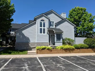 a house with a parking lot in front of it at Cozy, 4 Bedroom Chalet, 10 min walk to Village in Blue Mountains