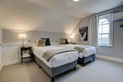a bedroom with two beds and a window at Historic Home in the Heart of Elora in Elora