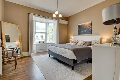 a bedroom with a bed and a window at Historic Home in the Heart of Elora in Elora