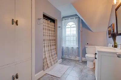 a bathroom with a toilet and a window at Historic Home in the Heart of Elora in Elora