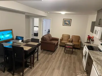 a living room with a table and a dining room at Modern, well-equipped, and centrally located in Fonthill
