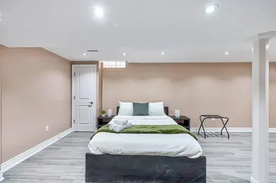 a large bedroom with a large bed in it at 4BR Scarborough Gem, Freshly Renovated, 7 Car Parking in Toronto