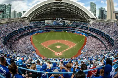 a crowd of people in a stadium watching a baseball game at 4BR Scarborough Gem, Freshly Renovated, 7 Car Parking in Toronto