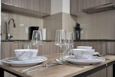 a table with plates and wine glasses on it at Pleasant 1BR Sofa Bed Close to UofT in Toronto