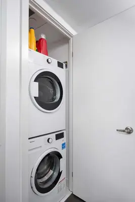 a washer and dryer in a utility room at Pleasant 1BR Sofa Bed Close to UofT in Toronto