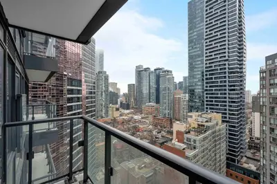 a view of a city from the balcony of a building at Pleasant 1BR Sofa Bed Close to UofT in Toronto