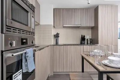 a kitchen with a table with wine glasses on it at Pleasant 1BR Sofa Bed Close to UofT in Toronto