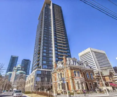 a tall building in a city with a building at 1560 sqft Elegant Condo at Downtown Hi-End Shopping & Dining Area - CN Tower View, Bidet, LockBox in Toronto