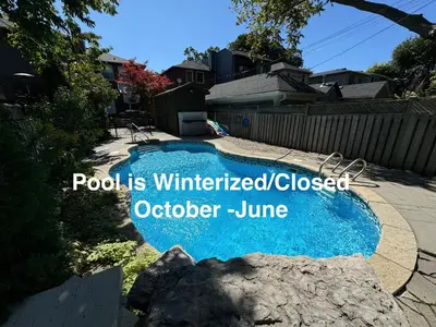 a pool isumedcolocolo october june sign in a backyard at Leaside Rental with Great Backyard & Pool in Toronto