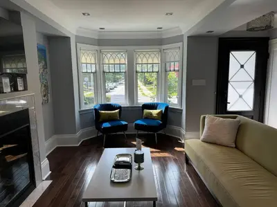 a living room with a couch and chairs and a table at Leaside Rental with Great Backyard & Pool in Toronto