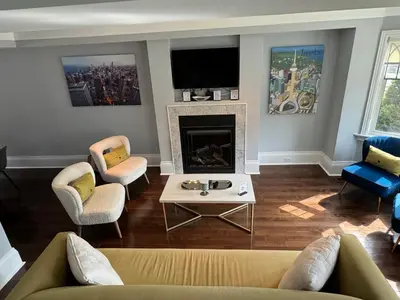 a living room with a couch and a fireplace at Leaside Rental with Great Backyard & Pool in Toronto