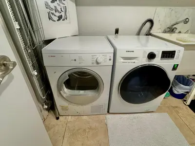 a washing machine and a washer in a kitchen at Leaside Rental with Great Backyard & Pool in Toronto
